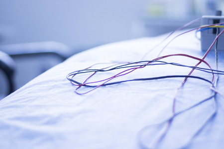 Dry needling electroacupunture cables connecting machine to needles used by acupunturist on patient...