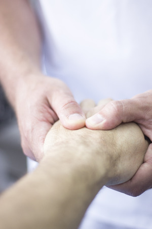 Myofascial osteopathy physiotherapy treatment by physiotherapist and osteopath in physical therapy rehabilitation treatment on patient on hand and wrist.の写真素材