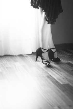 Female ballroom, standard, sport dance, latin and salsa dancer feet and shoes in dance academy school rehearsal room dancing salsa.の写真素材