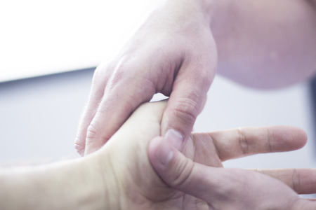Myofascial osteopathy physiotherapy treatment by physiotherapist and osteopath in physical therapy rehabilitation treatment on patient on hand and wrist.の写真素材