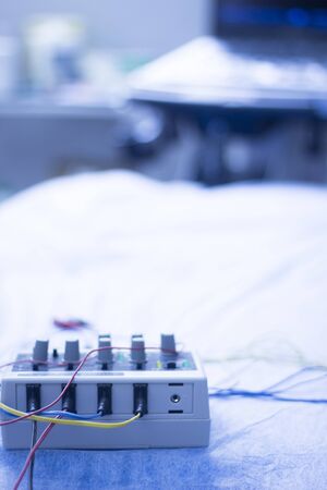 Dry needling electroacupunture cables connecting machine to needles used by acupunturist on patient...