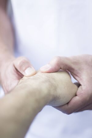 Myofascial osteopathy physiotherapy treatment by physiotherapist and osteopath in physical therapy rehabilitation treatment on patient on hand and wrist.の写真素材