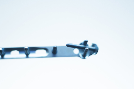 Orthopedics and Traumatology surgery plate & screws surgical titanium metal implant close-up...