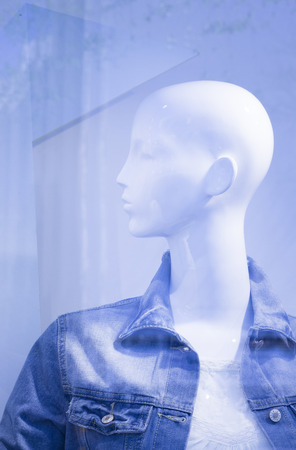 Store window fashion retail shop female mannequin bald dummy.の写真素材