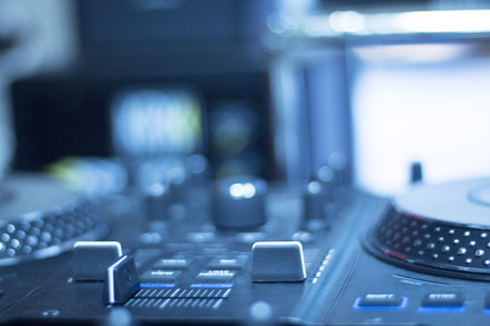 Ibiza dj turntables for deejay mixing in nightclub house music party at night during techno show.