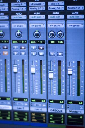 Professional sound recording audio studio digital equipment, amplifier, knobs and digital graphic equalizer controls on screen.の写真素材