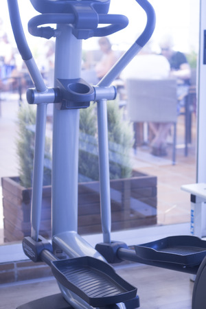 Gym exercise rowing machine static cross trainer eliptical step in fitness studio.の写真素材