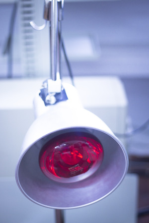Physical therapy equipment in physiotherapy center and medical clinic for red heat light treatment for injuries.の写真素材