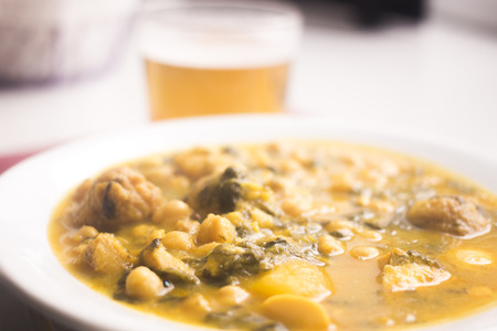 Beer glass and chicjk pea and bean Spanish tapas dish in restaurant cafe photo in Spain.の写真素材