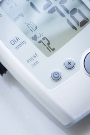 Portable hand held domestic cardiac blood pressure and irregular heart beat pulse rate meter to show resting heart rate in monitored patient.の写真素材