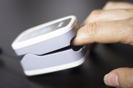 Portable hand held domestic cardiac finger pulse rate meter to show resting heart rate in monitored...