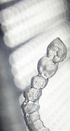 Invisible teeth aligner cosmetic orthodontic brackets used to straighten and align teeth in patient...