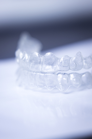 Invisible teeth aligner cosmetic orthodontic brackets used to straighten and align teeth in patient...