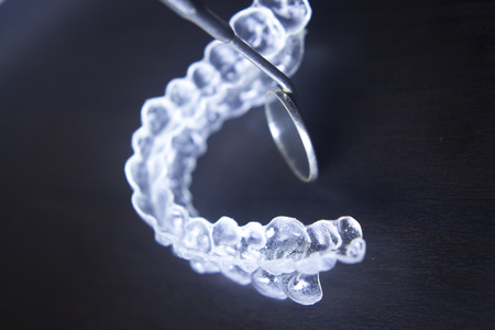 Invisible teeth aligner cosmetic orthodontic brackets used to straighten and align teeth in patient...