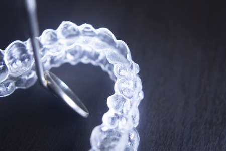 Invisible teeth aligner cosmetic orthodontic brackets used to straighten and align teeth in patient...