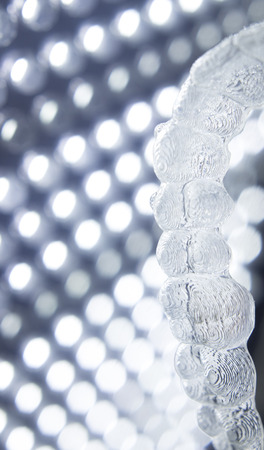 Invisible teeth aligner cosmetic orthodontic brackets used to straighten and align teeth in patient...