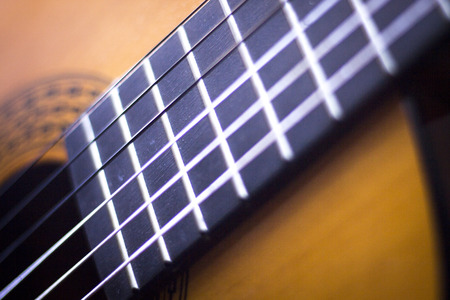 Spanish traditional flamenco wooden acoustic guitar strings and fretboard.