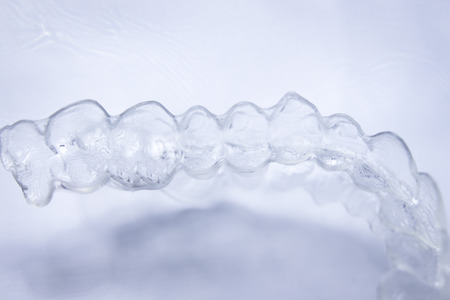 Invisible teeth aligner cosmetic orthodontic brackets used to straighten and align teeth in patient...