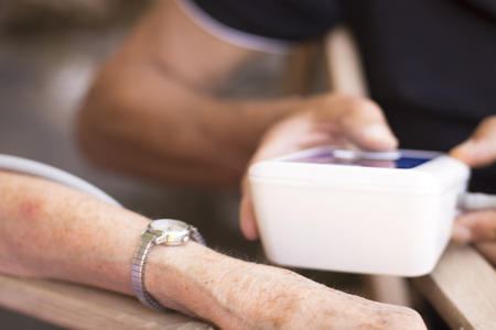 Cardiac blood pressure and irregular heart beat pulse rate meter to show resting heart rate in monitored old aged female patient.の写真素材
