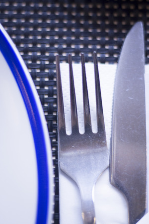 Asian chopsticks and knife and fork in Japanese restaurant to eat sushi and oriental cuisine.の写真素材