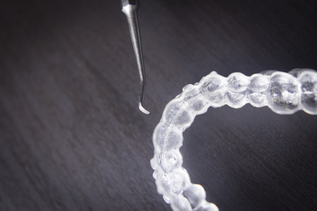 Invisible teeth aligner cosmetic orthodontic brackets used to straighten and align teeth in patient...