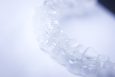 Invisible teeth aligner cosmetic orthodontic brackets used to straighten and align teeth in patient...