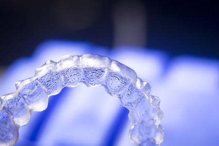 Invisible teeth aligner cosmetic orthodontic brackets used to straighten and align teeth in patient...