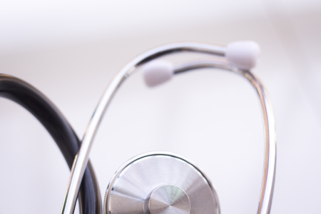 Medical doctor's stethoscope used to listen to patient heart rate, beats and monitor irregular heart beatsの写真素材