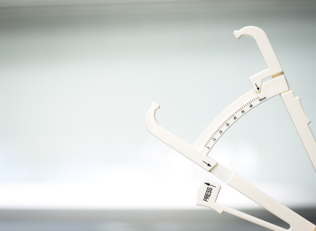 Bodyfat fat calipers used to measure percentage fat in different zones of the body for weight loss,...