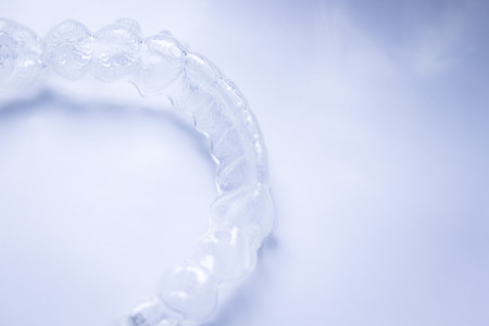 Invisible teeth aligner cosmetic orthodontic brackets used to straighten and align teeth in patient...