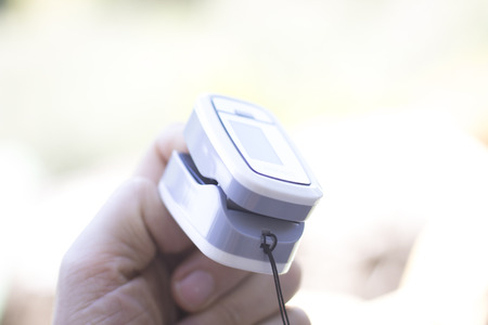 Portable hand held domestic cardiac finger pulse rate meter to show resting heart rate in monitored...