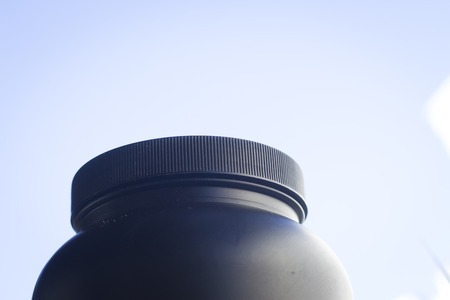 Protein isolated, concentrated and micro filtered whey and casein milk based powder sports protein supplement plastic container tub.の写真素材