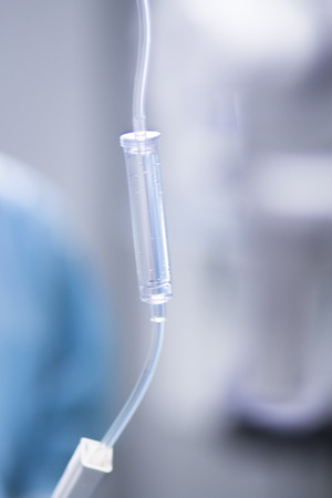 Medical intravenous IV drip in hospital used to replace liquids in patients in surgery in operating emergency room during operations.の写真素材