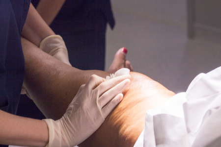 Anaesthetist pressing after anaesthetics injection before for surgical operation knee arthroscopy micro surgery in hospital.の写真素材