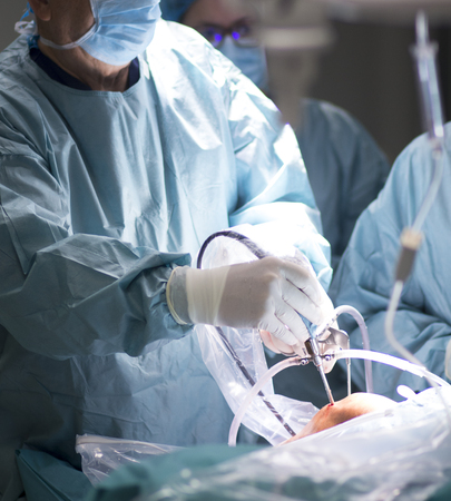 Surgeon in hospital surgery operating theater emergency room in blue doctor's surgical sterile...