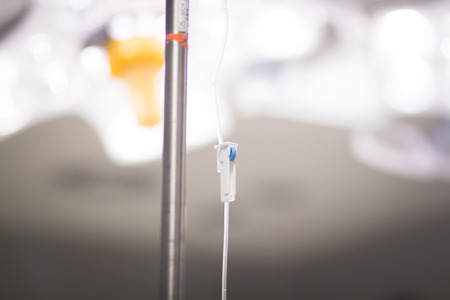 Medical intravenous IV drip in hospital used to replace liquids in patients in surgery in operating emergency room during operations.の写真素材