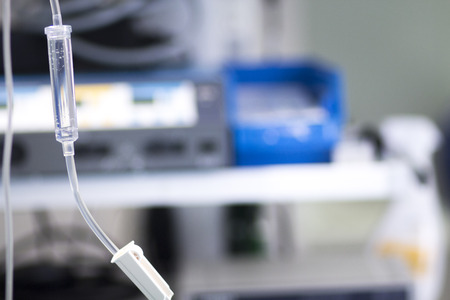 Medical intravenous IV drip in hospital used to replace liquids in patients in surgery in operating emergency room during operations.の写真素材