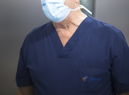 Surgeon in operating theater emergency room surgery in hospital clinic in blue surgical sterile uniform for operation.の写真素材