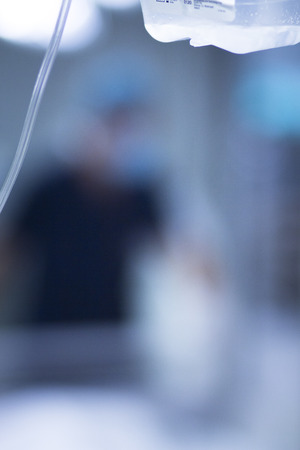 Medical intravenous IV drip in hospital used to replace liquids in patients in surgery in operating emergency room during operations.の写真素材