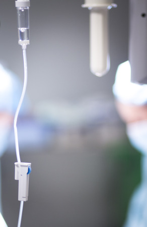 Medical intravenous IV drip in hospital used to replace liquids in patients in surgery in operating emergency room during operations.の写真素材