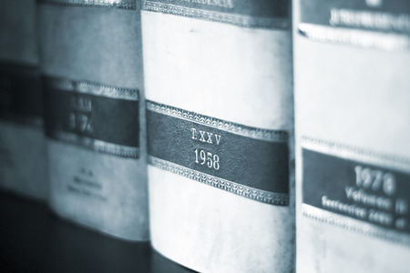 Old legal books law reports on shelves of law offices of attorneys and lawyers in judicial reference...
