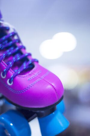 Childrens quad skate rollerskates in skate store in shop window display. Skates with four wheels and...