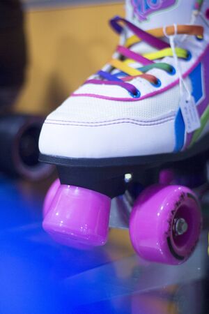 Childrens quad skate rollerskates in skate store in shop window display. Skates with four wheels and front brake for roller disco.の写真素材