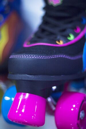 Childrens quad skate rollerskates in skate store in shop window display. Skates with four wheels and front brake for roller disco.の写真素材