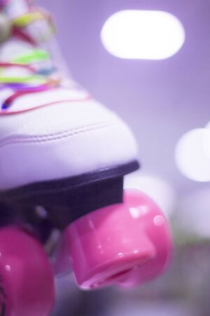 Childrens quad skate rollerskates in skate store in shop window display. Skates with four wheels and front brake for roller disco.の写真素材