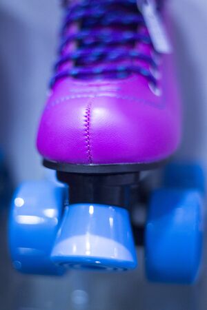 Childrens quad skate rollerskates in skate store in shop window display. Skates with four wheels and front brake for roller disco.の写真素材