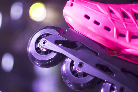 Freestyle pink ladies inline skates boots and wheels in retail store shop window for free, urban, slalom, fitness skating.の写真素材