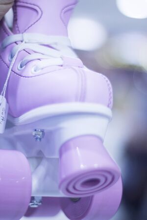 Childrens quad skate rollerskates in skate store in shop window display. Skates with four wheels and front brake for roller disco.の写真素材
