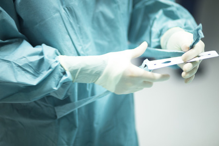 Surgeon in hospital surgery in sterile uniform "scrubs" in operating theater emergency room in surgical operation.の写真素材