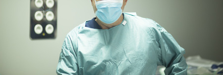 Surgeon in hospital surgery in sterile uniform "scrubs" in operating theater emergency room in surgical operation.の写真素材